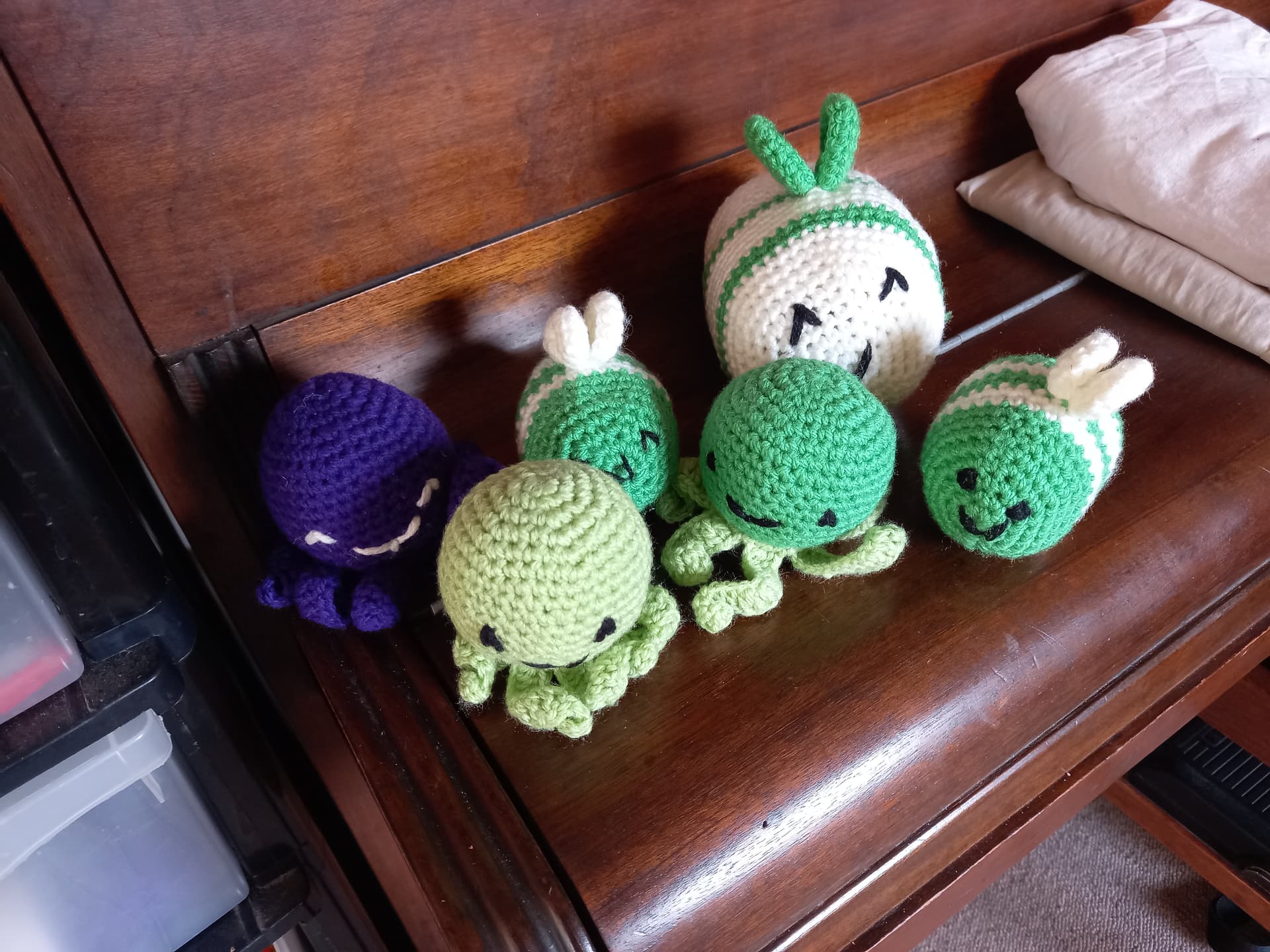 Small amigurumi crochet figures including octopus and bees