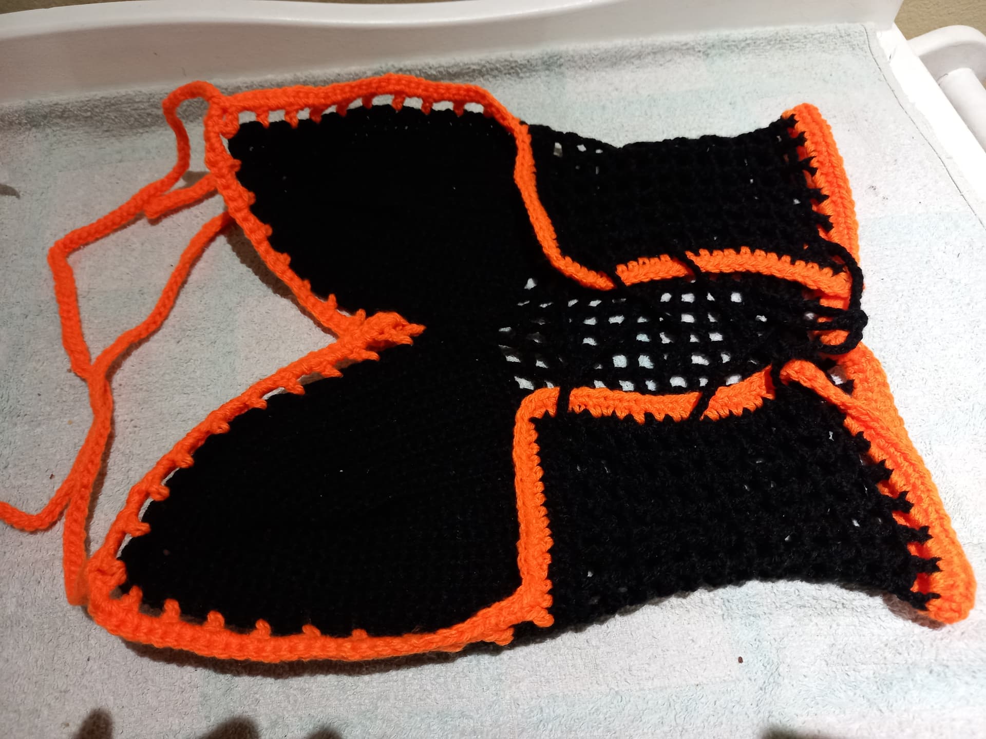 Black crochet butterfly top with bright orange borders