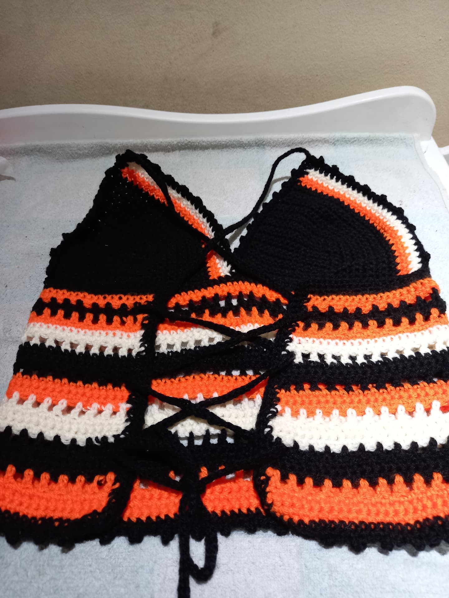 Black, orange, and white striped crochet crop top with lace-up back