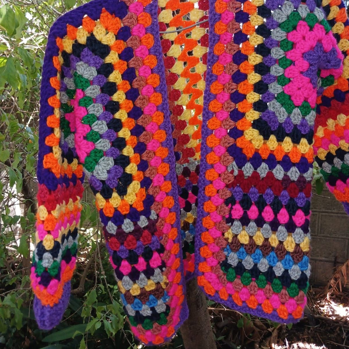 Colourful granny square crochet cardigan with purple trim