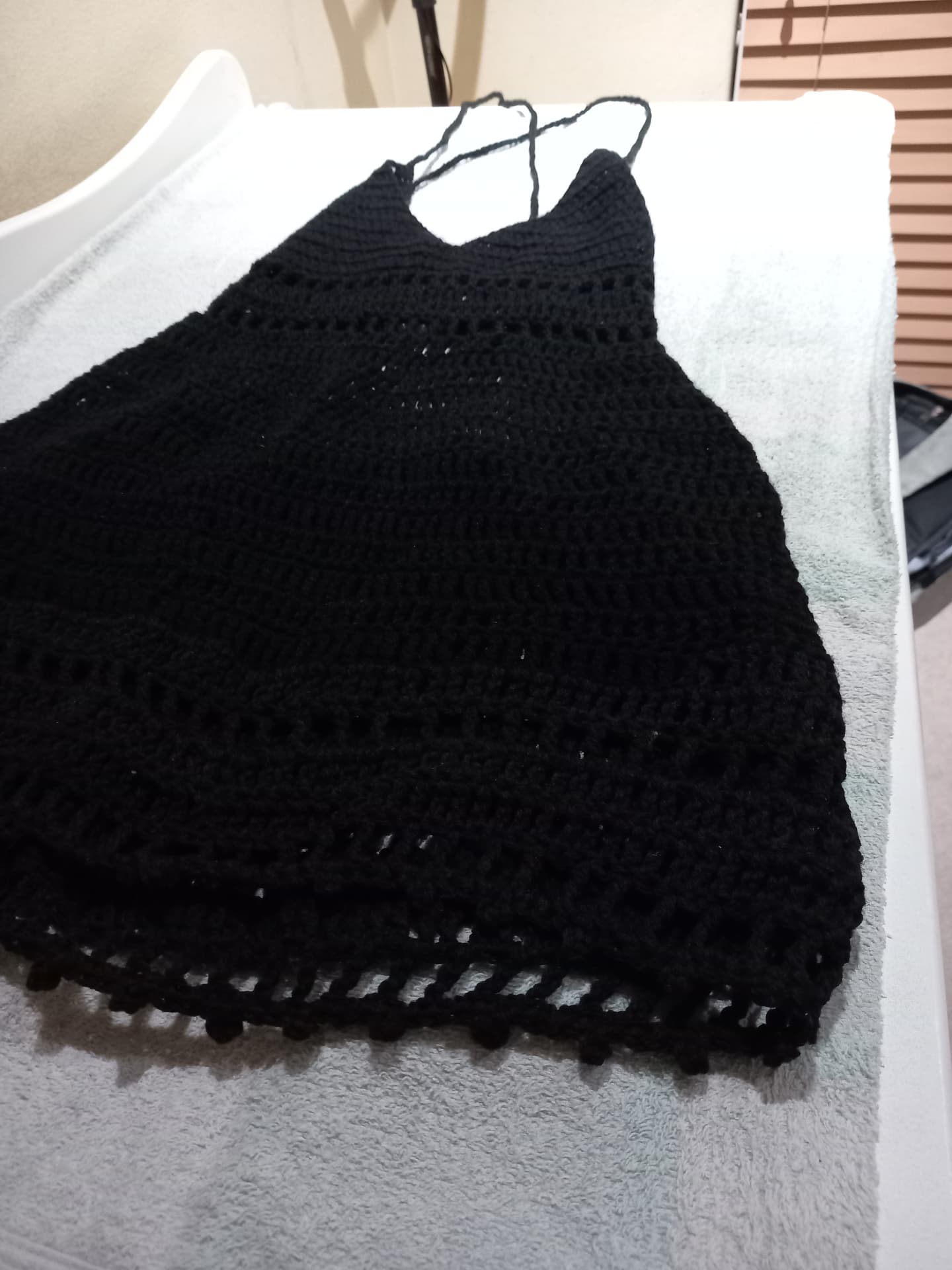 Side view of the handmade black crochet top